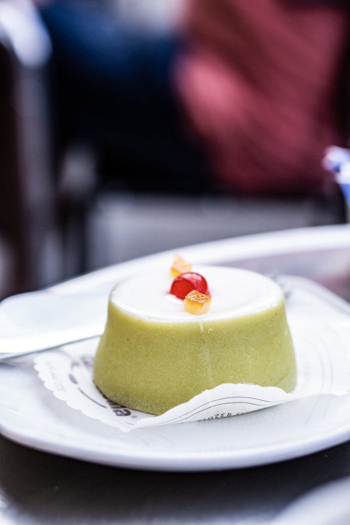 about-us-01 Close-up of a classic Cassata Siciliana dessert with candied fruits on a plate in Noto, Sicily.